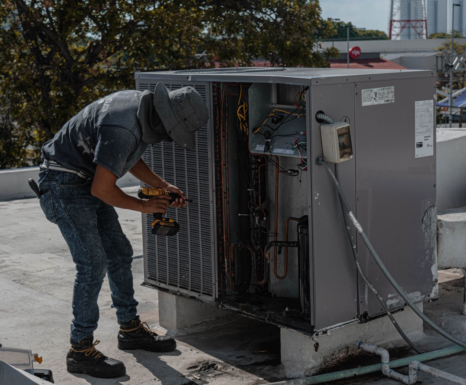 Technician servicing an outdoor air conditioning unit