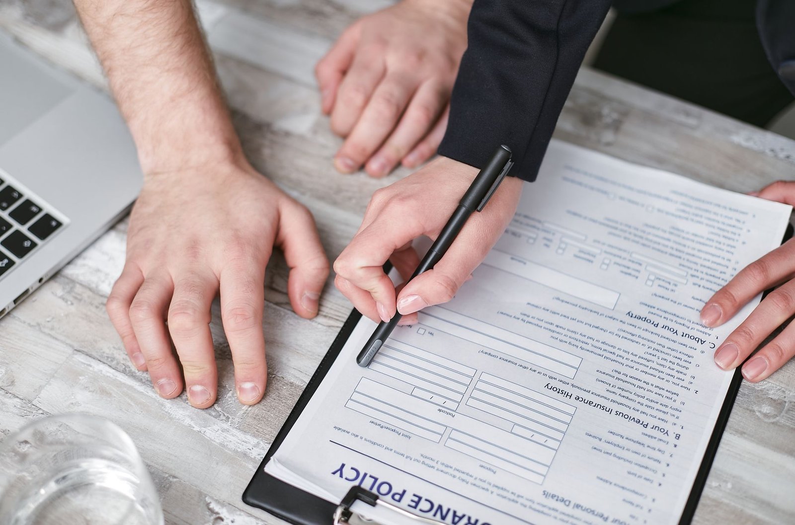 Two people signing an agreement